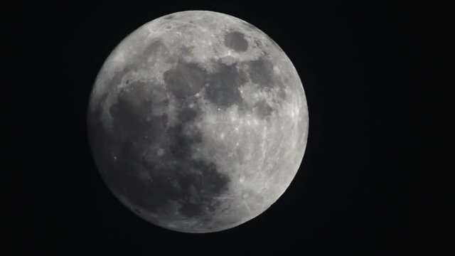 Timelapse of full moon in the sky at night 