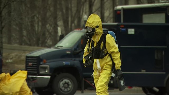 Security person in hazmat suit walking during a disaster drill