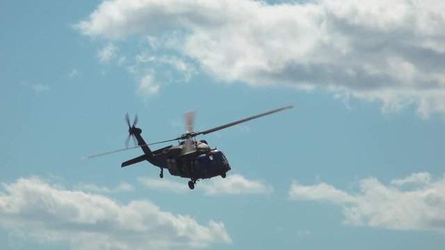 Tracking shot of military helicopters flying in the sky