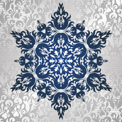 Decorative star on floral wallpaper in silver