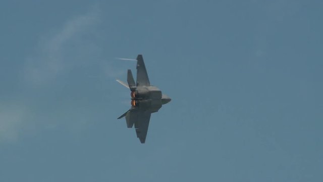 Tracking shot of military aircraft flying mid air in sky