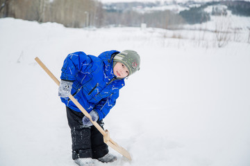 a little boy cleans snow © vitec40