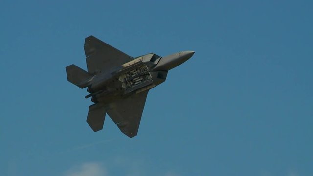 Tracking shot of f22 fighter jet flying in the sky