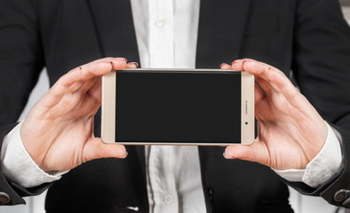 woman holds a smartphone