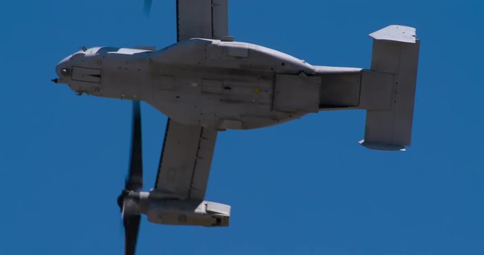 Low angle view of osprey helicopter flying in blue sky