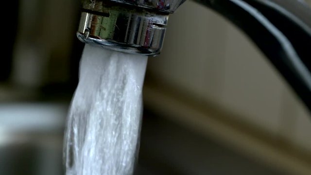 Close up of faucet running water
