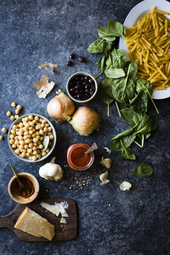 Ingredients for chickpea spinach pasta with olives (gluten-free