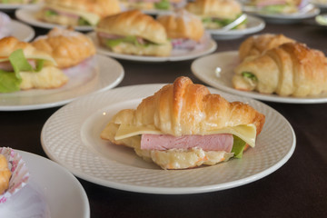 Croissant ham cheese on white plate for serving