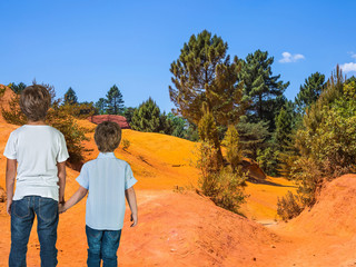 Two boys admired red hills