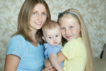 Happy embracing family members posing for indoor portrait