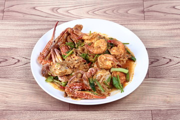 Stir-fried crab and shrimp in curry power is top-ten of popular Thai food as seafood to fried with  fresh milk ,grill curry ,egg ,oyster oil and yellow curry powder. 