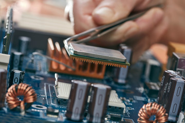 Engineer plug in CPU microprocessor to motherboard socket