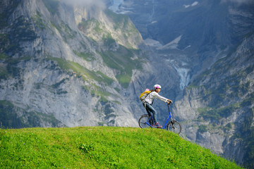 A woman ready to go down from hill by kick scooter at Bort stati