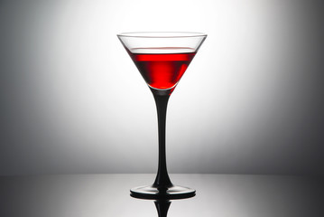 Red cocktail with liqueur in martini glass