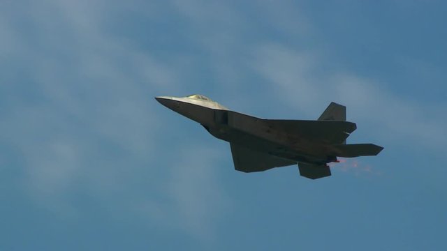 Tracking shot of F22 fighter jet flying in the sky