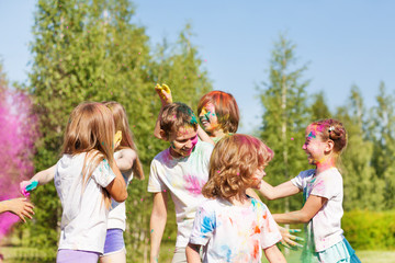 Happy kids having fun with colored powder outside