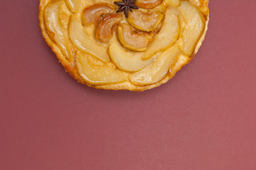 Tarte Tatin apple pear tart isolated on claret background