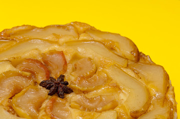 Tarte Tatin apple pear tart isolated on yellow background