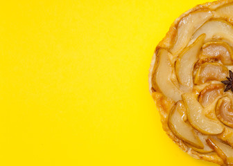 Tarte Tatin apple pear tart isolated on yellow background