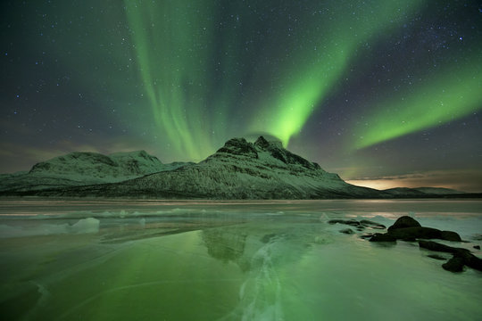 Aurora borealis over a frozen lake in northern Norway