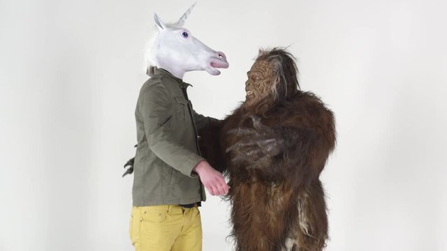 Bigfoot hugging a unicorn man