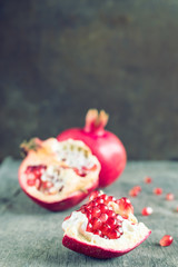 Ripe pomegranates on the background of the old wooden table