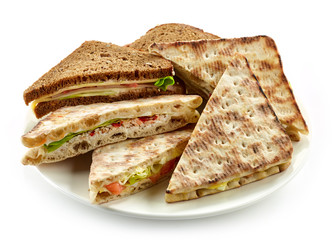 plate of various triangle sandwiches
