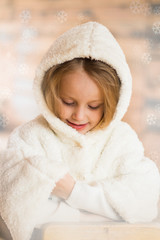 Girl in a fur coat in the hood on the eve of the new year