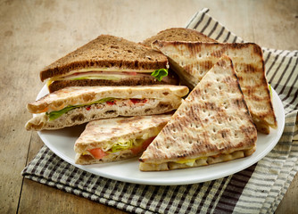 plate of various triangle sandwiches