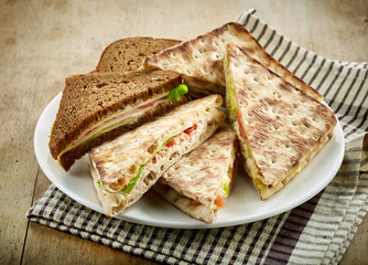 plate of various triangle sandwiches