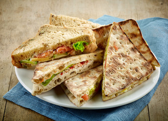 plate of various triangle sandwiches