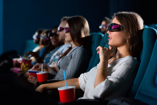 Attractive young woman enjoying movies at the cinema