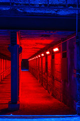 illuminated old passage underground of industrial plant by night, duisburg