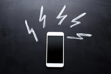 Smartphone on blackboard background