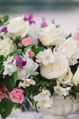 Decoration for a couple's romantic date or dinner on wooden pier on the riverside. Floral decoration closeup.