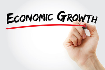 Hand writing economic growth with marker, concept background