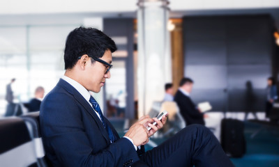businessman is Doing Business on mobile phone, while is sitting