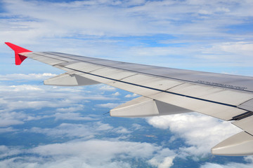 Fototapeta premium Clouds and sky as seen through window of an aircraft