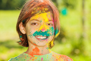 Portrait of happy boy smeared with colored powder