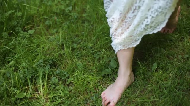 Bride is barefoot on a grass