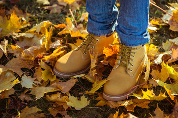 Warm yellow boots. Walking in autumn leaves