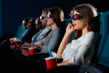 Attractive young woman enjoying movies at the cinema
