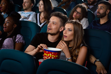 Lovely young couple on a date at the cinema