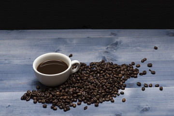 Cup with coffee and coffee beans