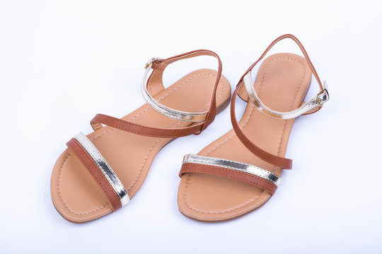 Women's brown sandals on white background. top view