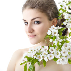 Beautiful happy young woman enjoying smell of a flowering spring