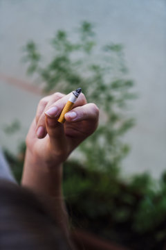 Hand with cigarette stub