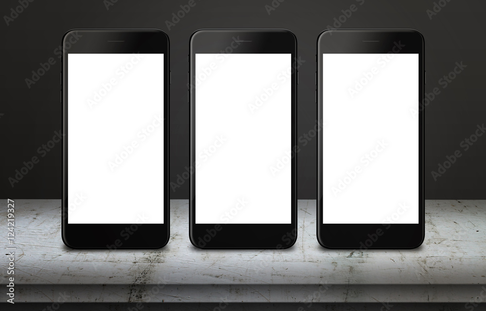 Poster Three white mobile phones on table with blank, white, isolated display screen for mockup. Mobile app or responsive web site presentation. Vertical position. White table and dark, black background.