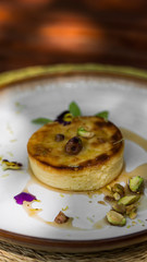 Pastry desert with nuts and syrup dressing on the side