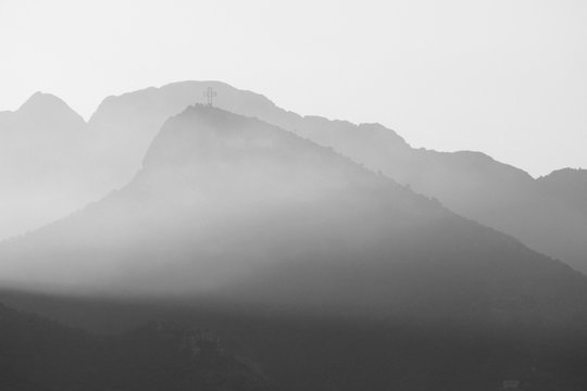 Fototapeta Black and white landscape with mountains, sky and fog